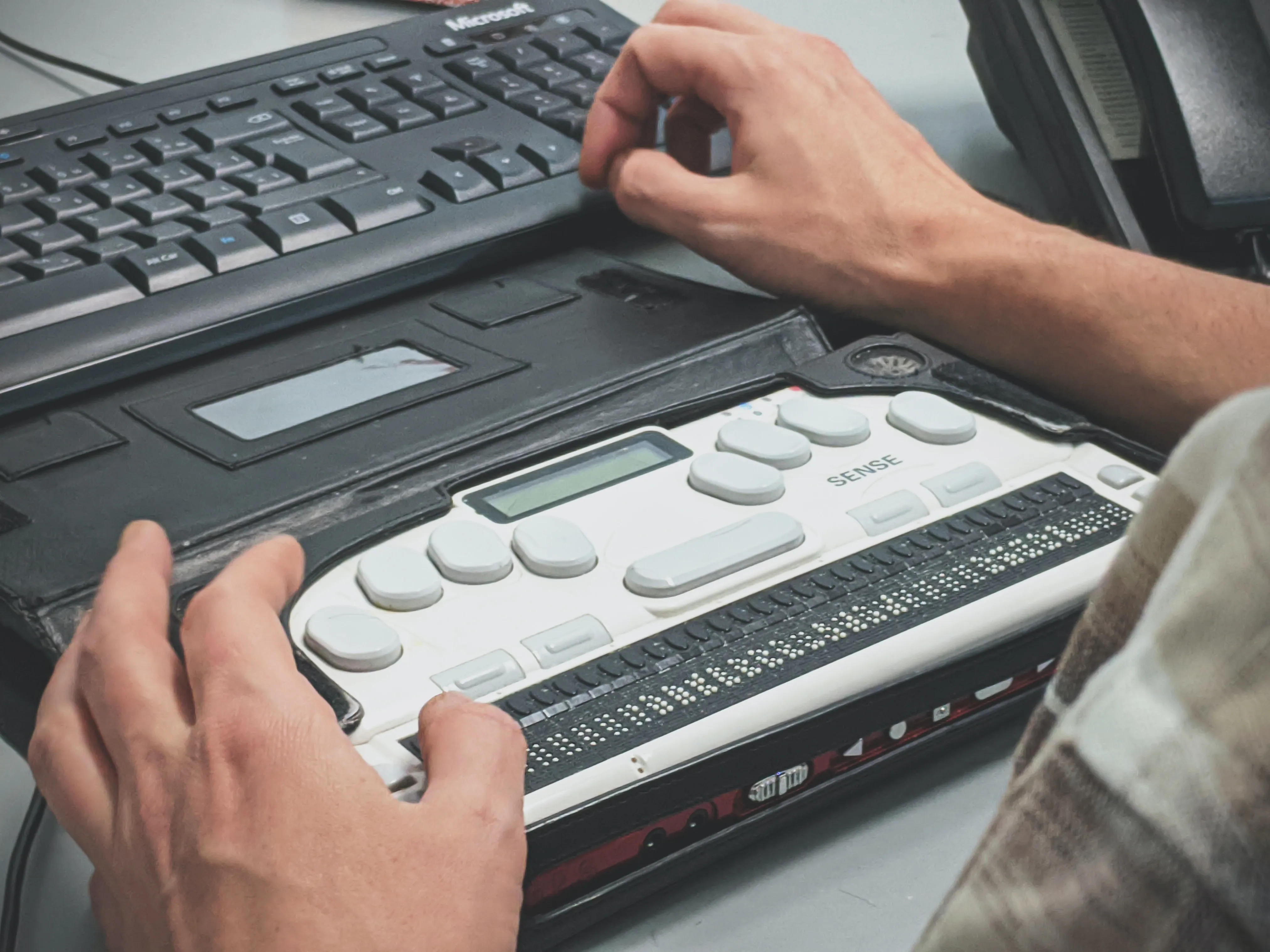 Hands on a braille screen reader